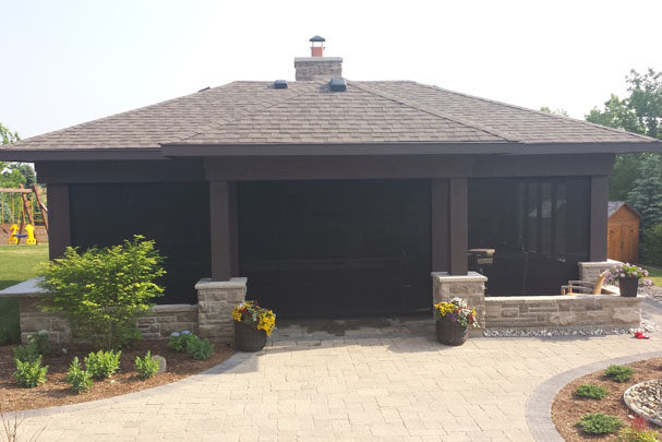 Black motorized privacy screen installed on a mondern cabana